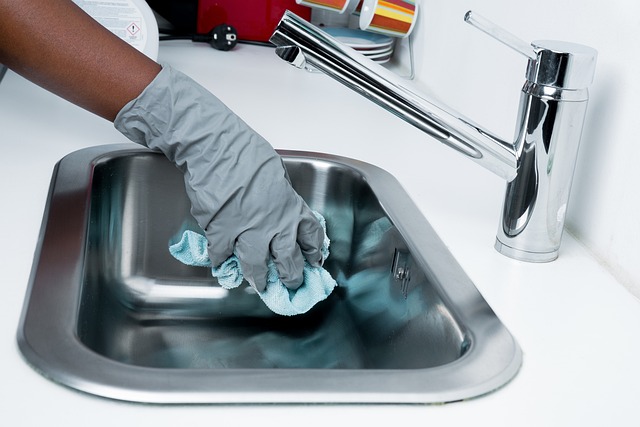 woman wiping down sink